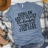 Being An Adult Is The Dumbest Thing Ever Screen Print Transfer, blue T-shirt with black printed humorous quote on adulting.