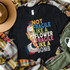Ruth Bader Ginsburg Fragile Like A Bomb Screen Print Transfer, a graphic t-shirt featuring an artistic portrait of Ruth Bader Ginsburg with colorful text emphasizing strength and resilience.