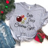 Balls Deep In Christmas Spirit Screen Print Heat Transfer, a festive gray sweatshirt with Christmas ornament design and humorous text, surrounded by holiday decorations including a Christmas tree, a gift box, and distressed denim jeans.
