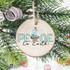 PEACE On Earth Sublimation Transfer, wooden Christmas ornament with peace and star design hanging on a Christmas tree branch.