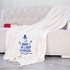 Baby It's Cold Outside Snowman Screen Print Heat Transfer, cozy cream-colored blanket with snowman design and text on a white sofa.