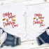 Chunky Thighs & Pumpkin Pies Sublimation Transfer, white T-shirts with pumpkin and pie graphics and playful red text, laid flat on a wooden surface with denim jeans and sneakers.