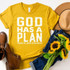 God Has A Plan Screen Print Heat Transfer, yellow t-shirt with white text, surrounded by a tan hat, sunflower bouquet, blue denim jeans, and brown shoes.