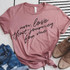 Um, Love that Journey For Me Screen Print Heat Transfer, pink T-shirt with black script text and knot at the bottom, styled with jeans and boots.