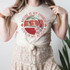 Nature Is My Church Screen Print Heat Transfer, a woman wearing a beige t-shirt with a nature-themed graphic and the text 'Nature Is My Church, Love Is My Religion'