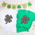Lace 4 Leaf Clover Sublimation Transfer, green and black lace designed four-leaf clover on t-shirts with st. patrick's day decorations.