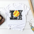 LOVE Softball Sublimation Transfer, designed with a yellow softball featuring red stitching inside the word 'LOVE' printed on a white T-shirt.
