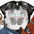 Dreamer Screen Print Heat Transfer, colorful graphic of a pair of wings with feathers and the word 'DREAMER' in stylized text on a black and white speckled background.