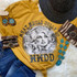 What Would Dolly Do Screen Print Heat Transfer, a graphic t-shirt with a portrait of Dolly Parton, fashion accessories including turquoise jewelry, a woven hat, and striped bandana, laid out on a soft surface for display.