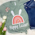 Hoppy Easter Rainbow Screen Print Heat Transfer, colorful rainbow with bunny ears and heart in the center on a green T-shirt.