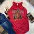 High Voltage Tiger Screen Print Heat Transfer on red sleeveless T-shirt featuring a fierce tiger and lightning design, alongside denim jeans, a colorful belt, zebra print clutch, and striped earrings, all laid out on a plush white rug.