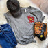 You're Outta Here Softball POCKET Screen Print Heat Transfer, gray t-shirt with red and yellow screen print baseball graphic and text, paired with a black and tan Wilson baseball glove, a black distressed baseball cap, and blue denim jeans, laid on a white faux fur background.