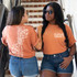 Grow Through It Spine SET with POCKET Screen Print Heat Transfer, two women wearing orange t-shirts with the design, one showing the front with the text and the other the back with the spine graphic.