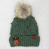 Reindeer Leather Patch, green knitted winter hat with faux fur pom-pom on top.