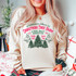 Griswold Christmas Tree Farm Screen Print Heat Transfer, a festive Christmas-themed heat transfer design with trees and holiday text, worn on a sweatshirt.