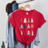 Boho Trees Screen Print Heat Transfer, festive Christmas-themed red T-shirt with colorful abstract tree designs tied at the waist.