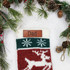 Custom Text Brown Leather Patch, a personalized leather patch attached to a Christmas sock with snowflakes and reindeer design, surrounded by holiday greenery and pinecones.