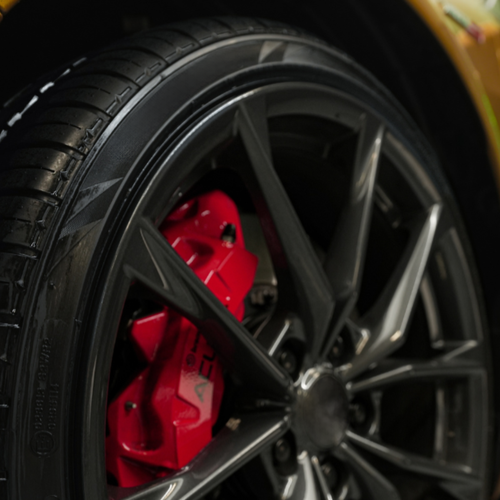 Detailed shot of tire with Wipe New Blazing Wet Tire Shine applied for a deep black finish and vibrant wheel contrast