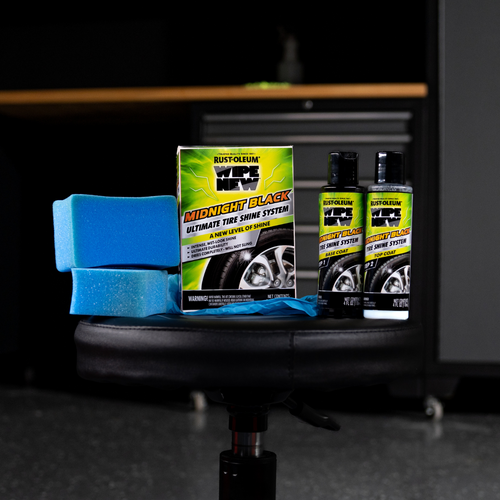 Full kit of Wipe New Midnight Black Tire Shine System including sponges and two-step solution bottles on stool