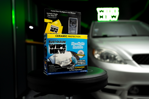 Rust-Oleum Wipe New Headlight Restore kit on a stool with a silver car in the background.