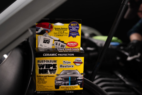 Rust-Oleum Wipe New Trim Restore kit on an engine. Includes wipes and instructions.