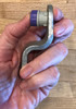 Step 3:  Place driver under thumb and bushing 'tang' or teeth edge down away from driver as shown. May use thumb or
pliers as shown to push or press  bushing into place.