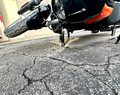 Protective Delrin shock slider keeping Harley Nightster elevated during fall