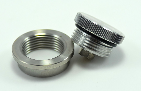Vented aluminum filler cap with weld-in bung and brass vent fitting, 1.25"-12 thread, compact design for gas or oil tanks.