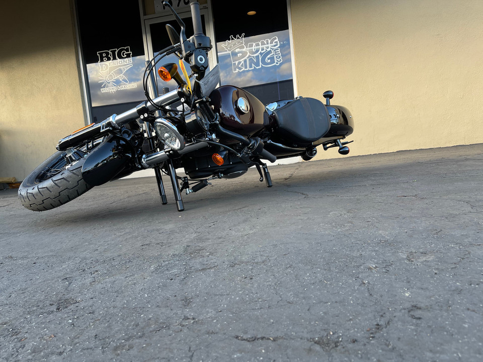 Harley Sportster tipped on its side resting on Bung King 2 Step Crashbar Harley Sportster tipped on its side resting on Bung King 2 Step Crashbar