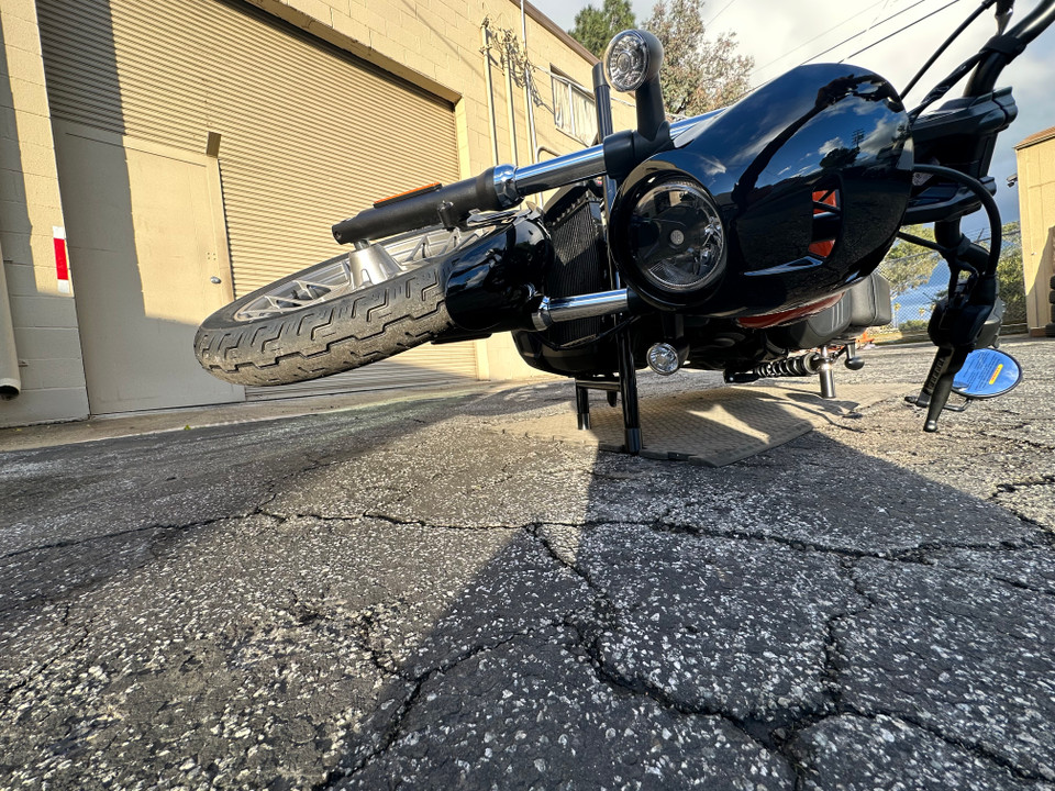 Nightster on its side with Bung King shock sliders preventing major damage