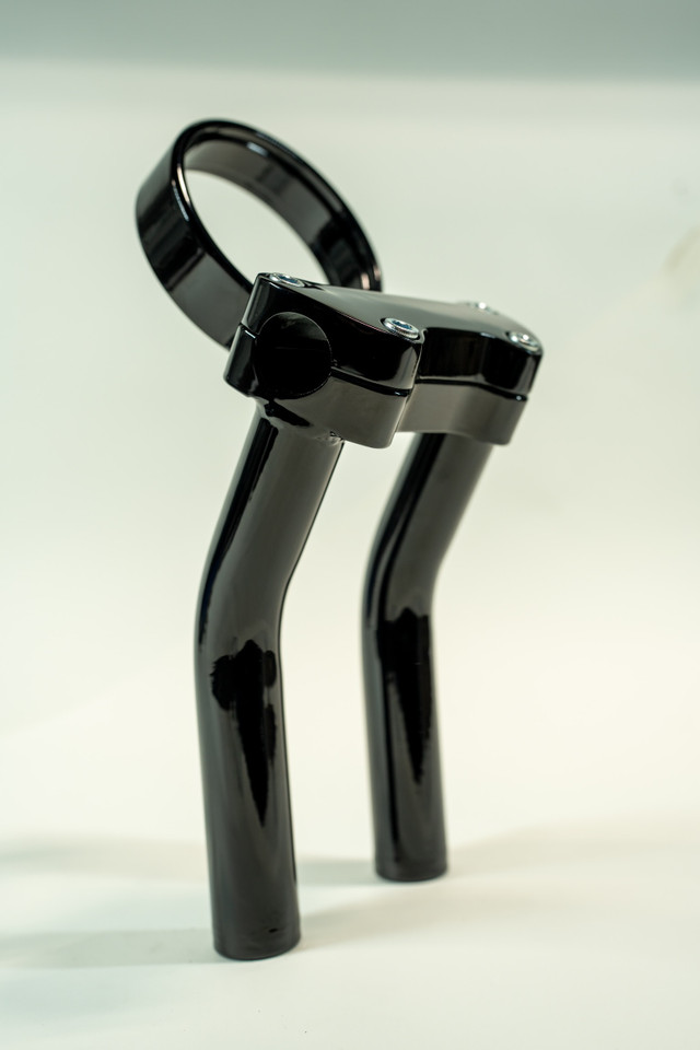 Complete Bung King riser assembly in gloss black finish with adjustable gauge mount on white background