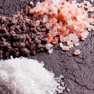 On a Keto Diet? Get Your Healthy Magnesium Supplements Here Picture of three different kinds of salt on a black slate.