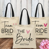 Team Bride Customized Canvas Tote Bags - Modern Wedding Bridesmaid Bags with Names -  Personalized Bridal Party Totes - Bridal Shower Gifts for Guests - Minimalist Bachelorette Party Tote Bags with Black Script Print and Pink Heart 
