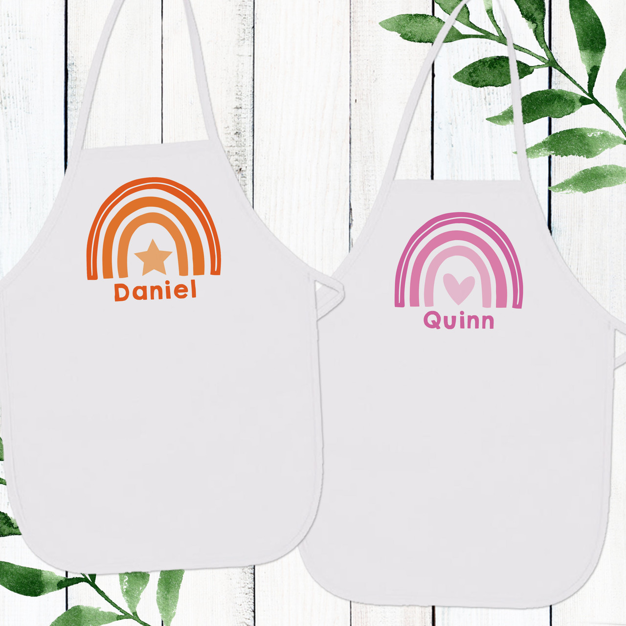 https://cdn11.bigcommerce.com/s-5grzuu6/images/stencil/1280x1280/products/6550/53532/Watercolor-Rainbow-Personalized_Kids_Aprons_Orange_Pink__56233.1677617872.jpg?c=2