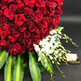 All of My Heart is a show stopping massive heart shaped design of  signature premium red rose accented with white orchids and lush tropical greens that clearly reads a luxury grand gesture hand created by Lexis Florist in Houston