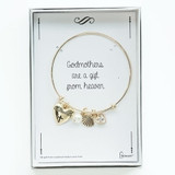 Gold Godmother Bracelet. The Godmother Bracelet is 2.5"D and is adjustabl. the Godmother Braclet is adorned with a heart, shell, and crystal charm and a pearl. the Godmother Bracelet is made of Brass/glass.