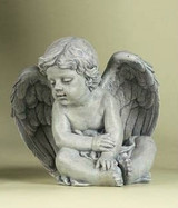 Angel figure sitting and leaning to the side. 