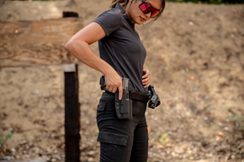 Shooter exercising trigger discipline while holstering pistol
