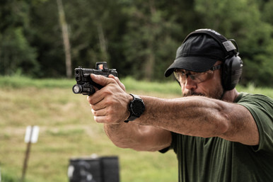 Shooter with M&P Shield X with mounted Holosun RMR and Streamlight TLR-7X