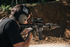 Man aiming M&P 15 Volunteer through mounted Trijicon ACOG.