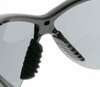 Close-up detail of frameless safety glasses with integrated nose piece and temple connection