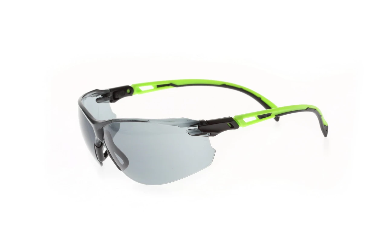 Smoke lens safety glasses with green and black frame, angled front view