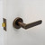 Manovella Fairhaven Lever Door Handle - Round Rosette - 57mm - Aged Brass
