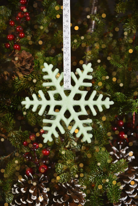 Handmade cast glass grass green frosted snowflake ornament.
