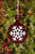 Handmade transparent red fused glass ornament with a modern twist on a classic design. Includes a dense white snowflake design element.