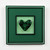 Deep green cast glass heart with complementary three-dimensional kilncarved frame.