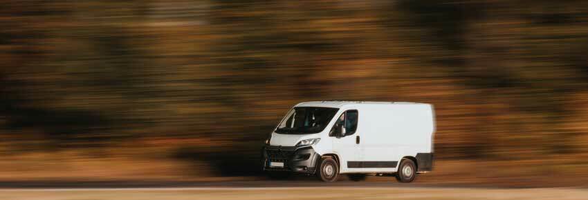 Red van with Free Delivery Service written on the side.