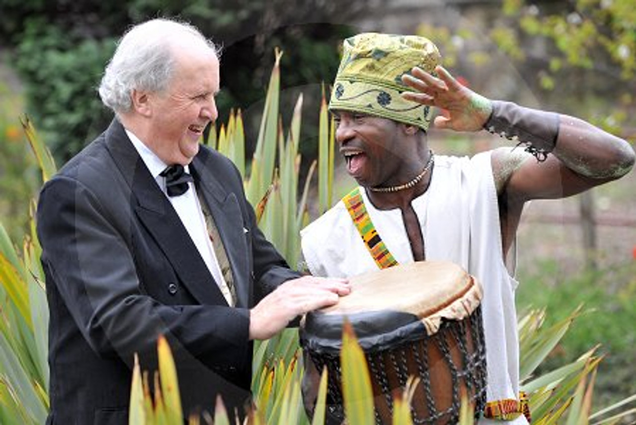 14722467 Scots Author Alexander McCall Smith bangs the drum with African bongo drummer Sam Okono at a press call to announce the UK premiere of his