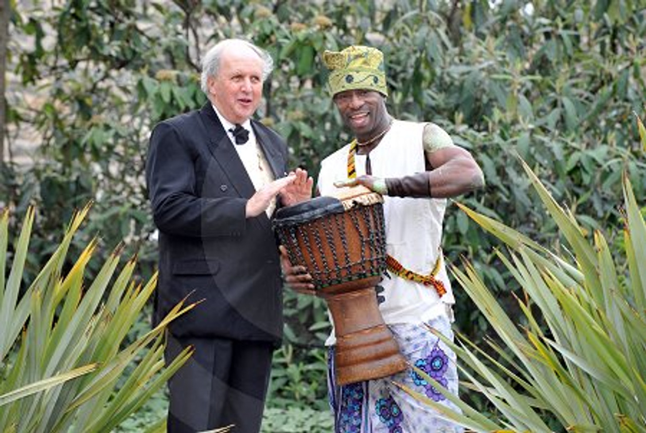 14722471 Scots Author Alexander McCall Smith bangs the drum with African bongo drummer Sam Okono at a press call to announce the UK premiere of his