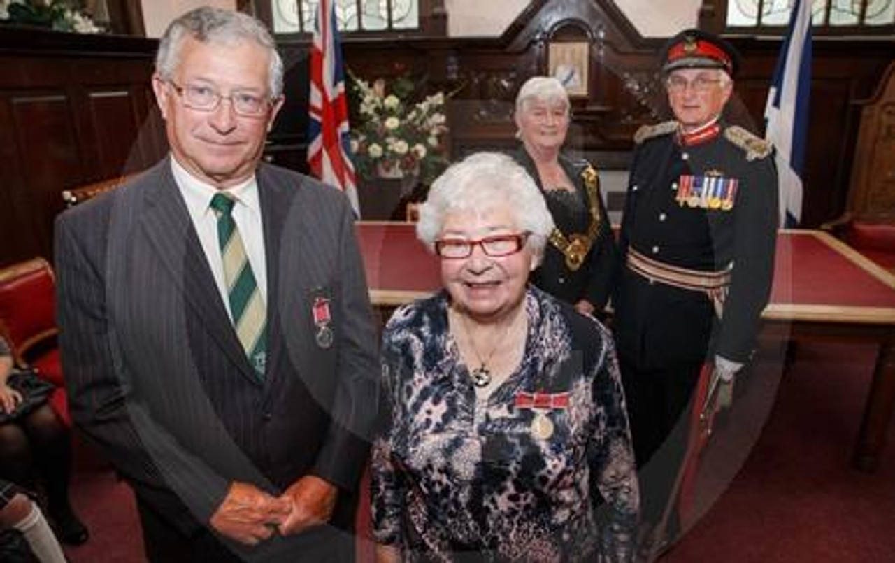 25783553 Beatrice Robertson and Paul Rey from Helensburgh presented with the British Empire Medal from Lord Lieutenant Rear Admiral Michael Gregory